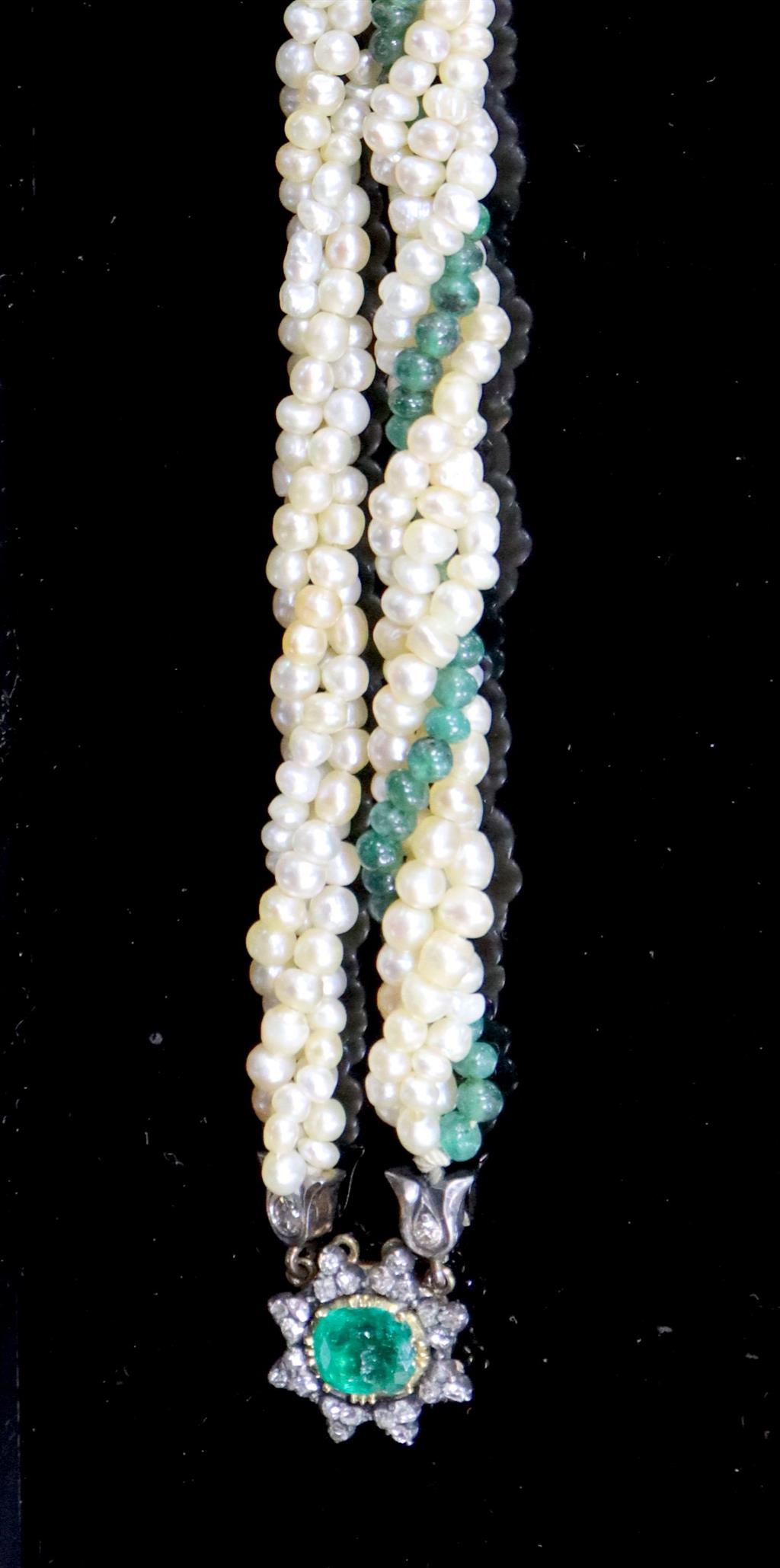 An early 20th century interwoven seed pearl and emerald bead bracelet, with foil backed emerald and diamond cluster set gold clasp,